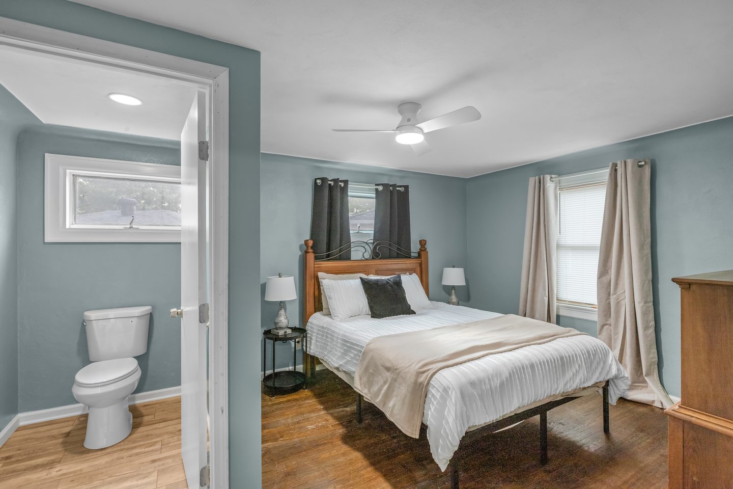 The same bedroom with the door open to its own bathroom