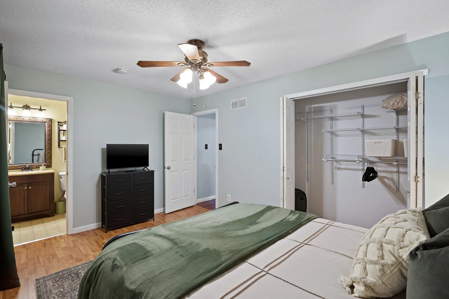 The green bedroom from the other side, with a walk-in closet and a door through to its own bathroom
